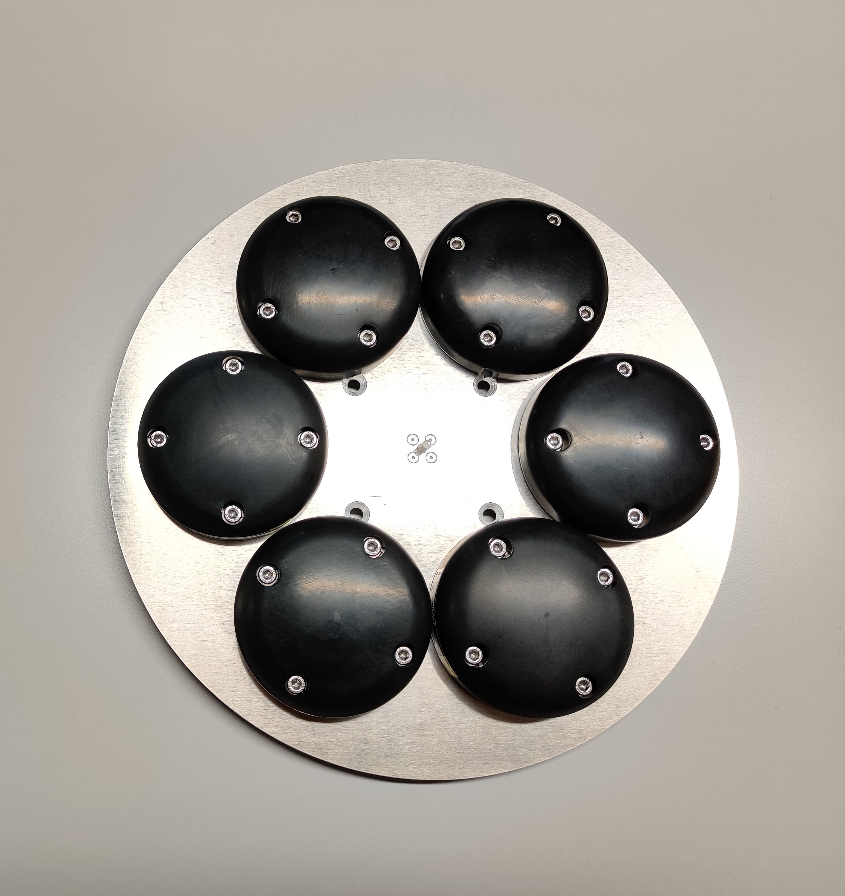 TeleOrbit's GNSSA-6E six-element antenna pictured from above showing the six black antenna eements mounted on the metal base plate